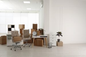 Cardboard boxes and packed stuff in office. Moving day